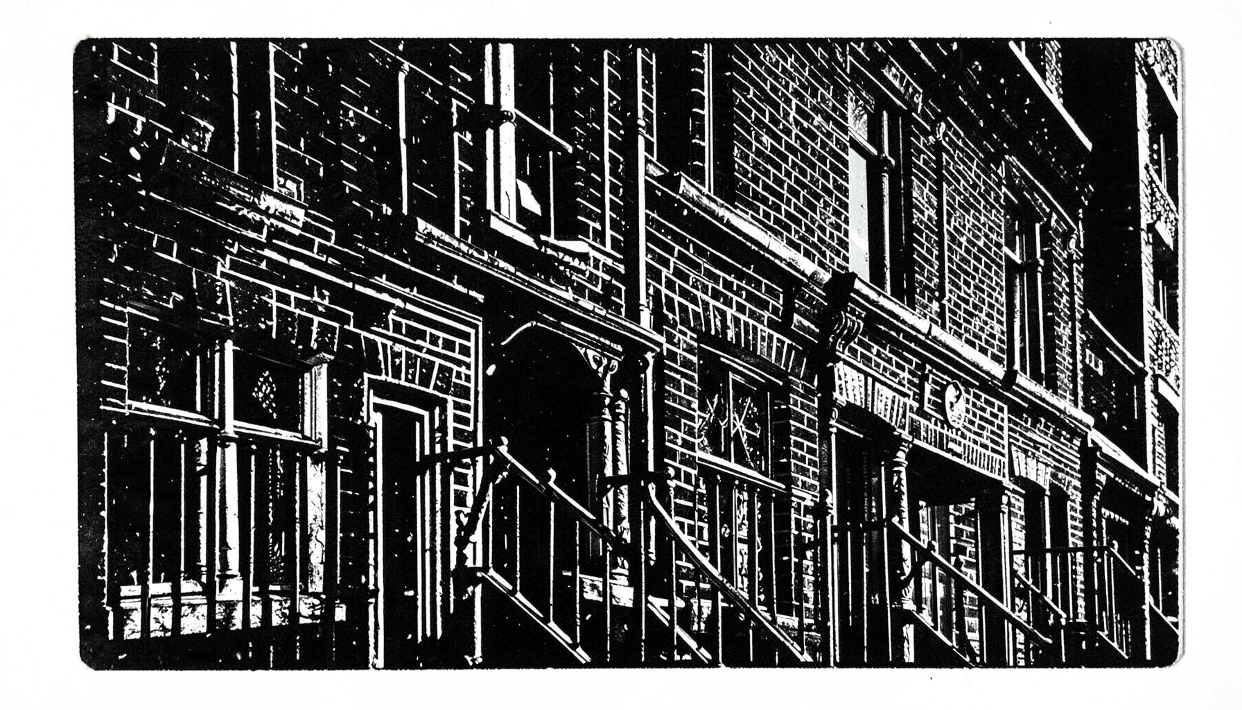 A carved linocut relief print in black ink showing the brick facades and iron railings of a Shoreditch mews, with deep shadows and a moody, hand-pressed texture.