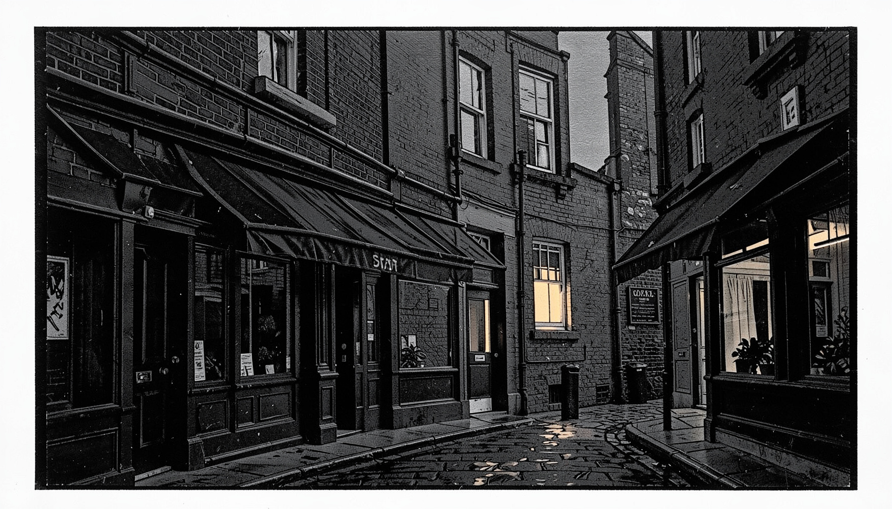 A wide monochrome photograph of a quiet Shoreditch street at dusk, with brick shopfronts, dark awnings, and a single warm window glowing against deep charcoal walls.
